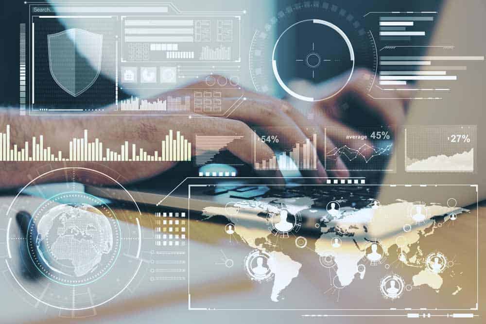 hands typing on laptop with superimposed icons of charts and maps